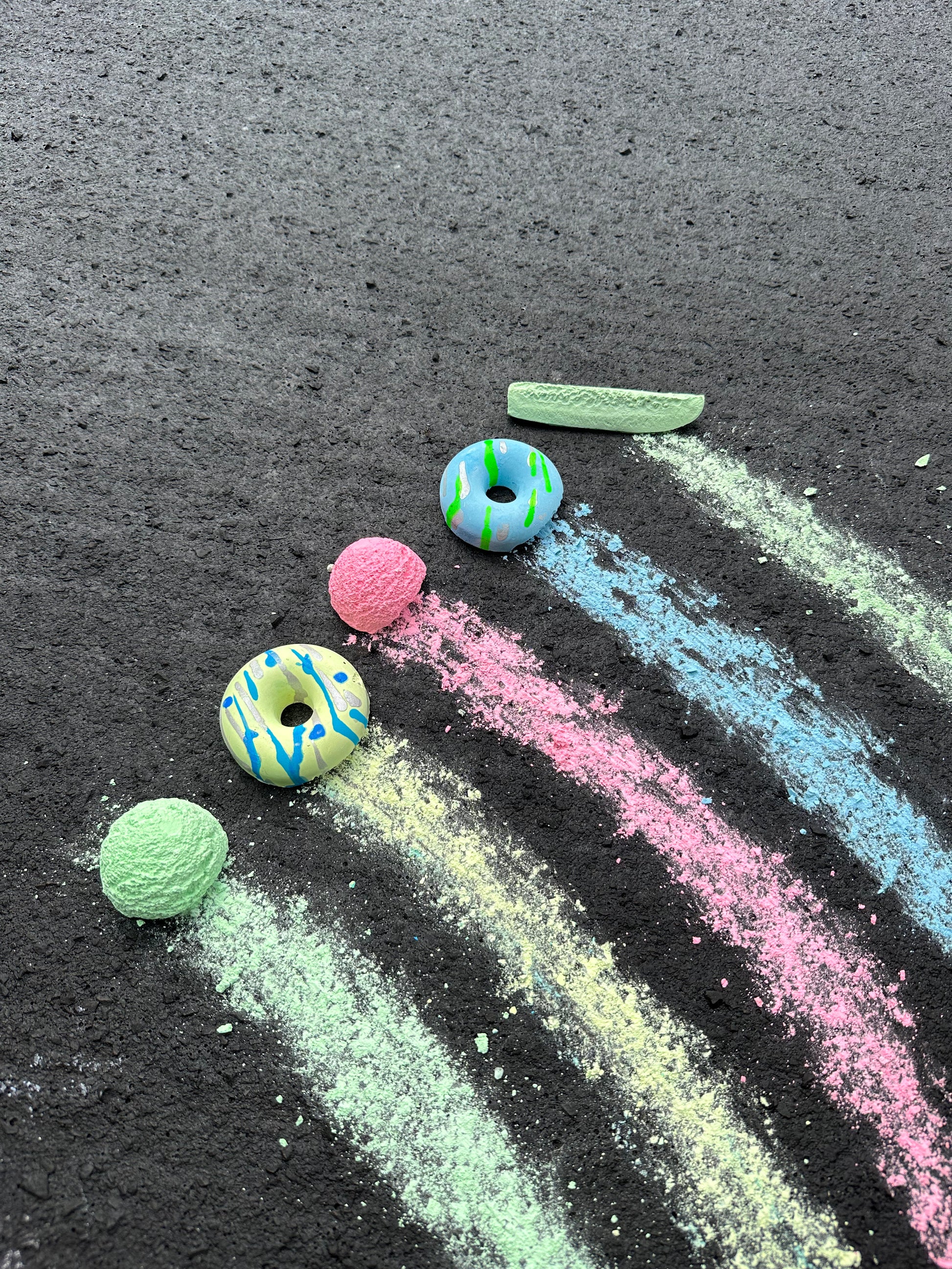 Handmade sidewalk chalk galactic bagel and pickle colors, art